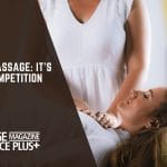 A woman receiving a Reiki treatment while lying down. 'Reiki vs Massage: It’s Not a Competition' text overlay with Massage Magazine Insurance Plus+ branding.